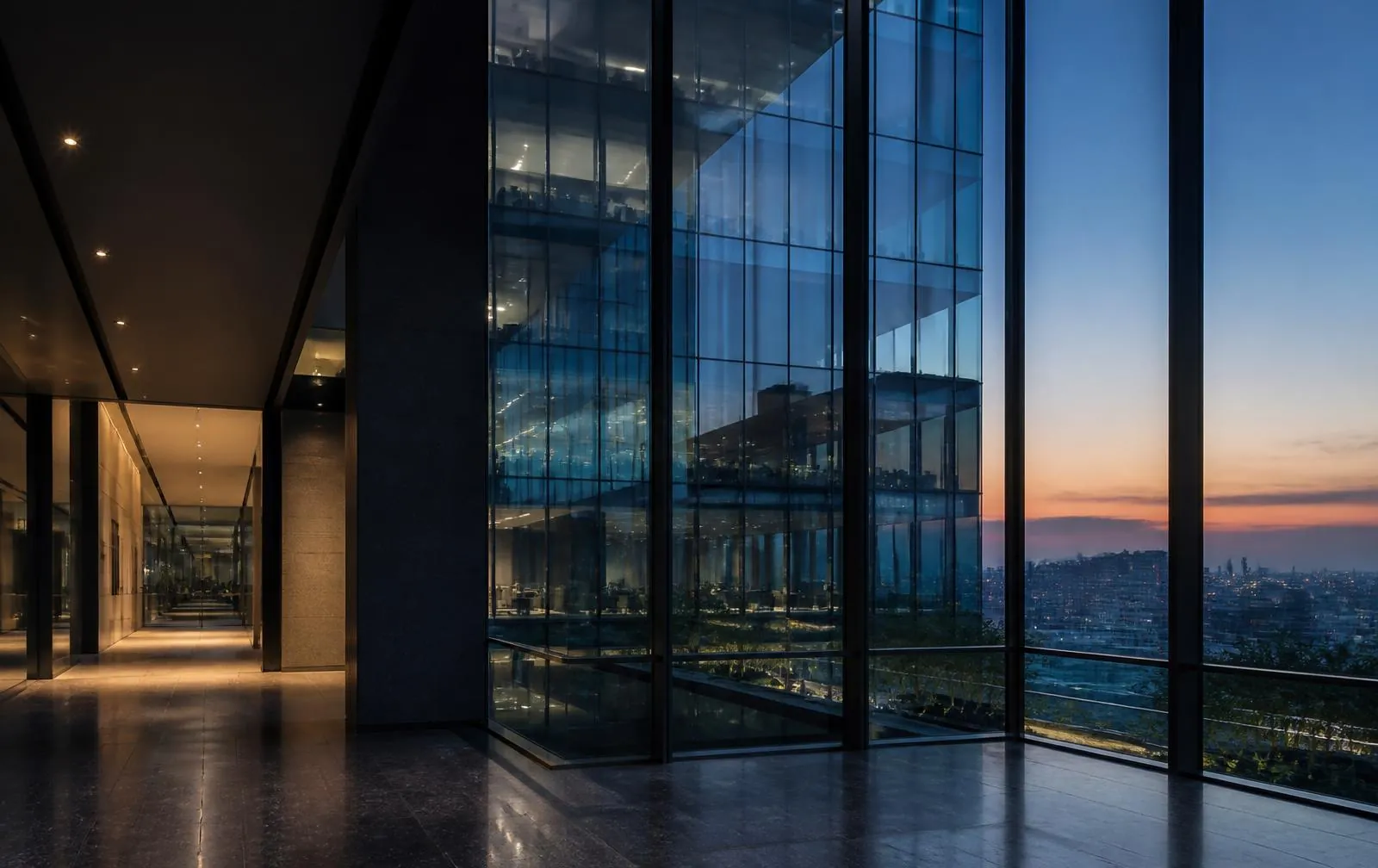 Modern glass office tower interior at dusk with blue reflections and clean geometry
